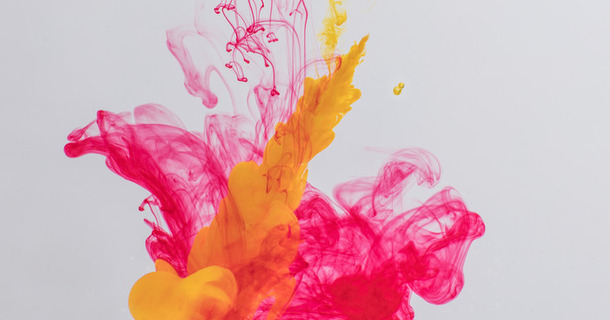 Colorful acrylic ink in water over gray background. Abstract background. Color explosion