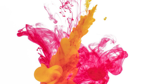 Colorful acrylic ink in water over gray background. Abstract background. Color explosion